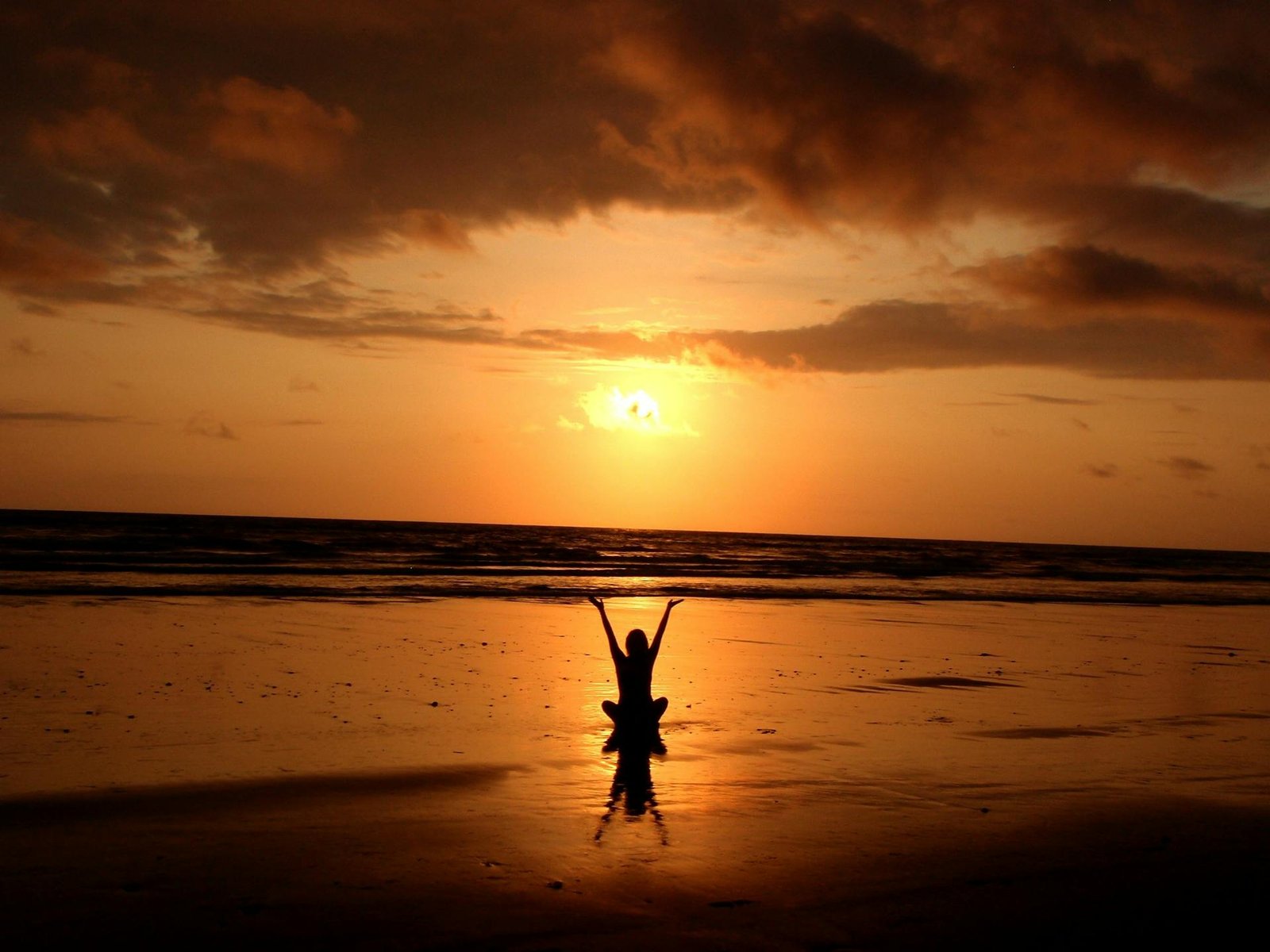 happy woman at sunrise on a beach